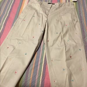 Tan capri’s with multi colored flowers.